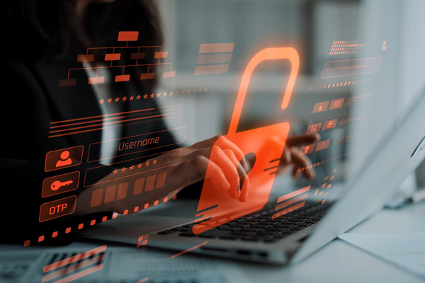 Person typing on laptop with a digital overlay showing an unlocked lock