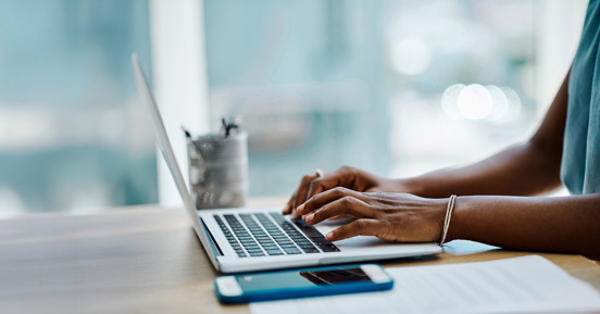 Woman typing on laptop