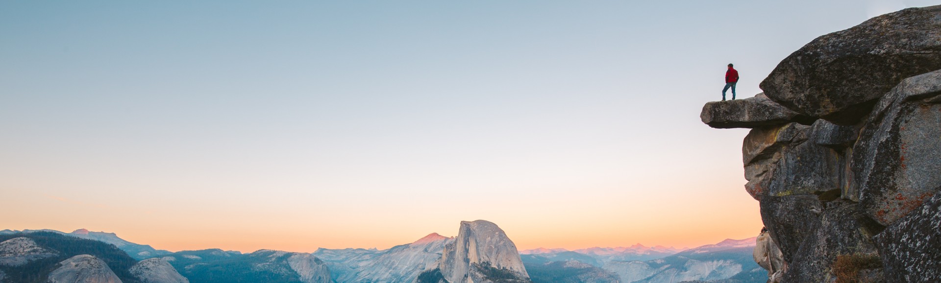 man-standing-on-cliff